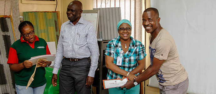 Alhaji Oshikoya, the nursing officer at Nigerite Limited presenting certificate to a participant